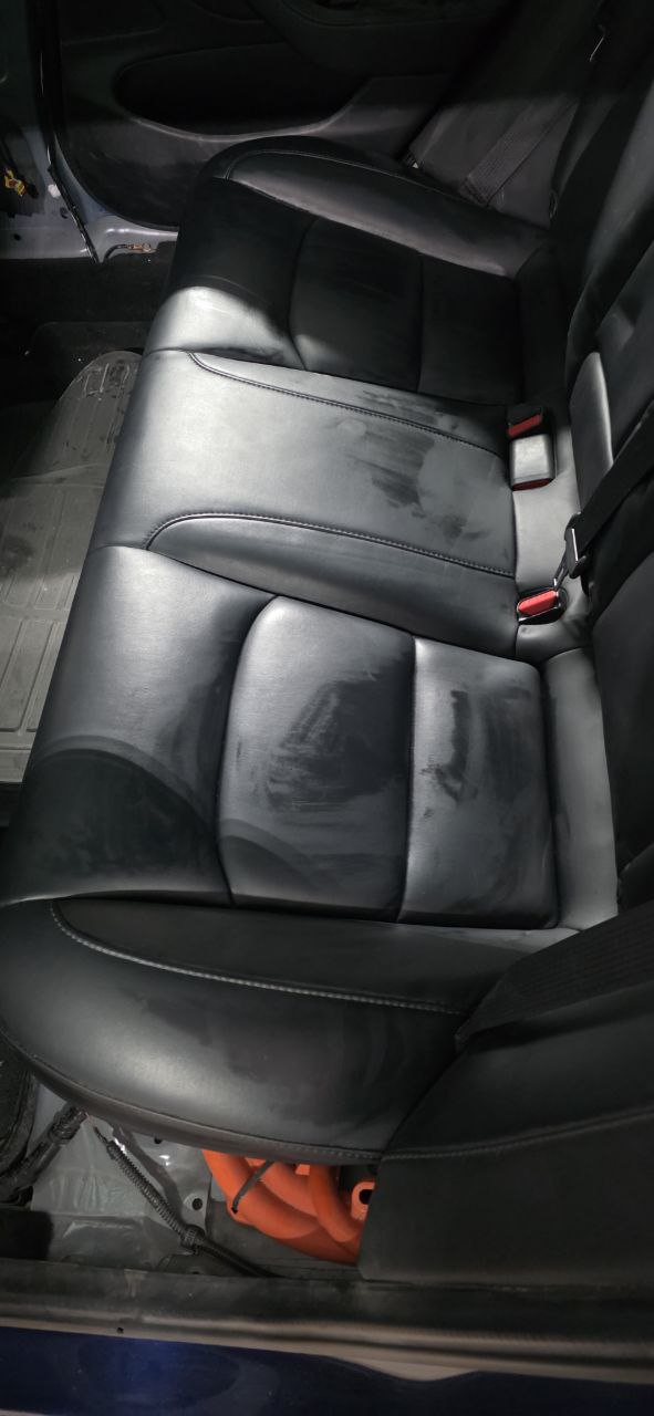 Tesla Model 3 rear bench seat lifted showing battery penthouse access