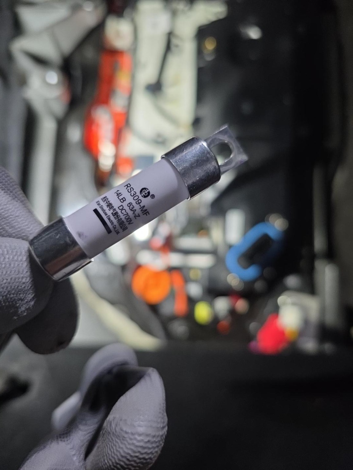 Removed fuse from the Model Y repair case, with RS309-MF, 63 A and DC700V markings visible