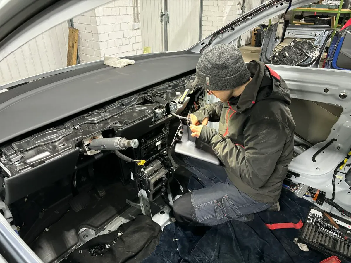 Tesla dashboard removed showing HVAC system during repair